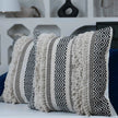 Set of two boho fringe pillows with geometric patterns.