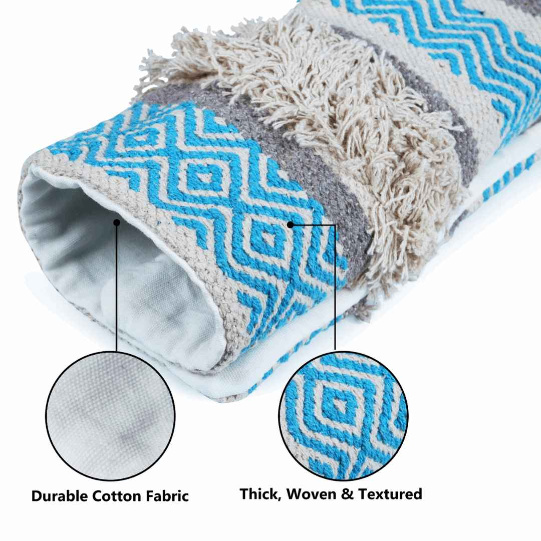 Close-up of boho pillow cover showing durable cotton fabric interior and thick, woven, textured blue and beige chevron pattern exterior with shaggy detailing.
