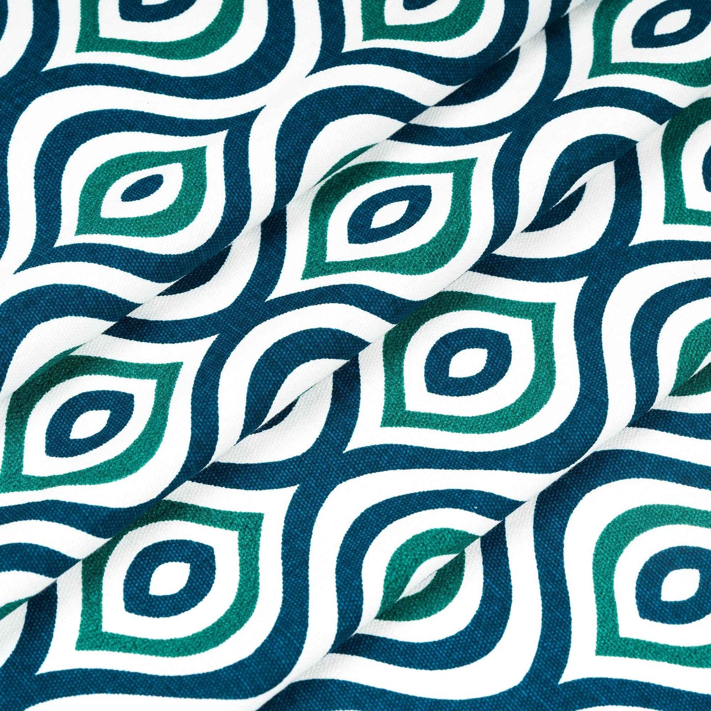 Folded fabric with bold green and navy blue diamond pattern on white background, ideal for modern curtains or upholstery.