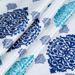 Close-up of blue and teal medallion print fabric white background