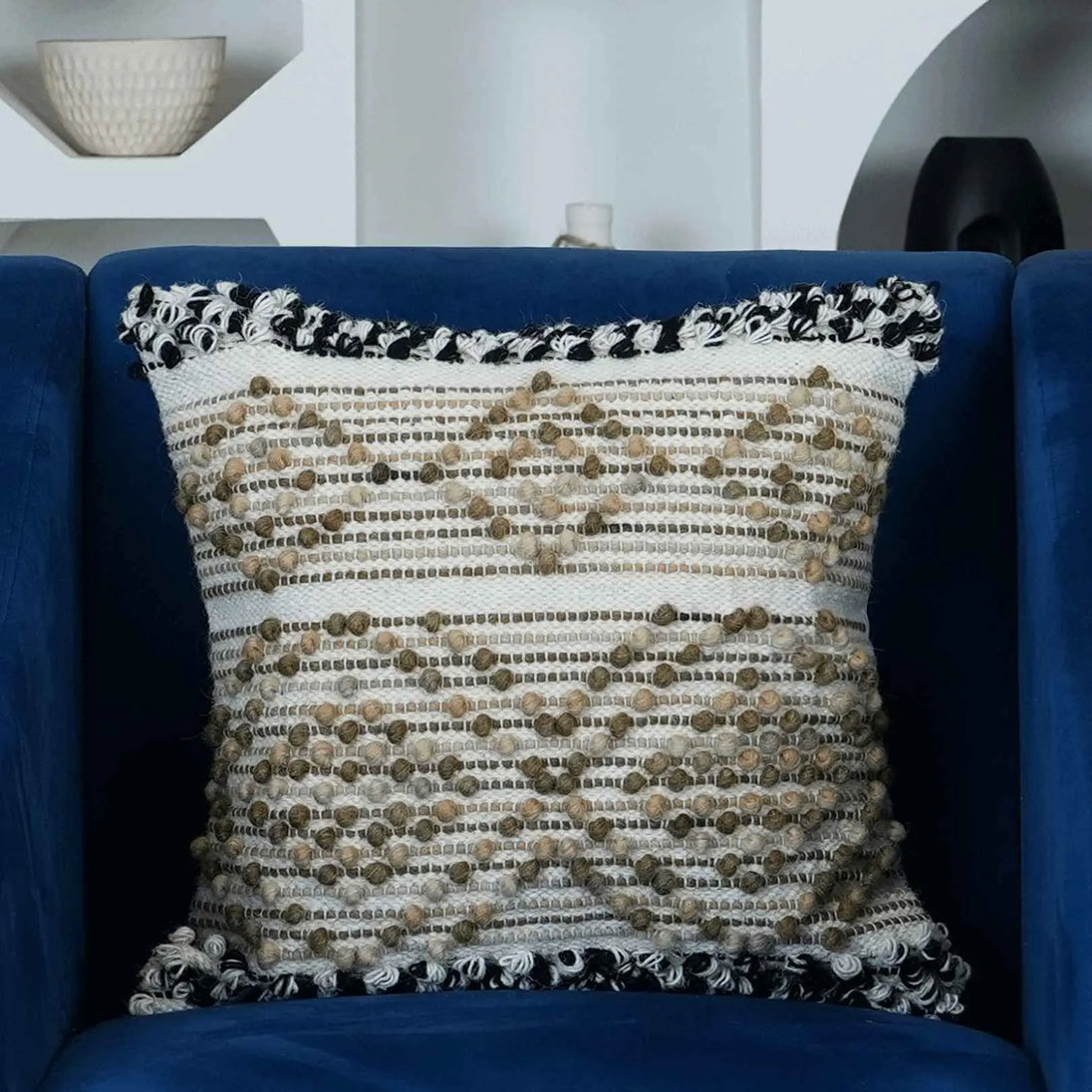 Boho decorative pillow on blue accent chair
