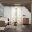 Soft floral curtains in cozy wooden attic room.
