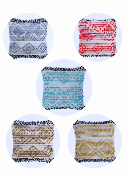 Five decorative square cushion covers in a variety of colors—blue, red, turquoise, beige, and yellow—featuring textured woven patterns and black-and-white tassel edging, displayed in circular frames on a light background.
