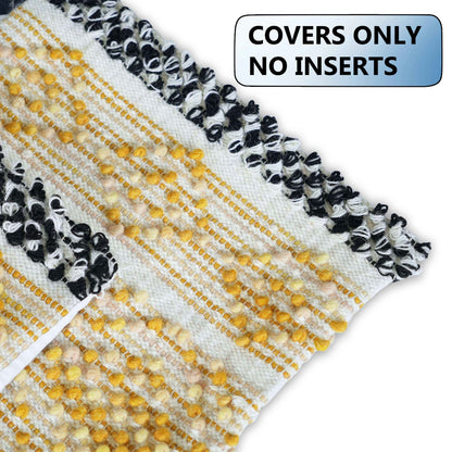 Close-up view of a handcrafted cushion cover featuring mustard yellow tufted detailing on a cream woven base, with bold black and white braided trim along the edge. Text overlay states "COVERS ONLY - NO INSERTS."







