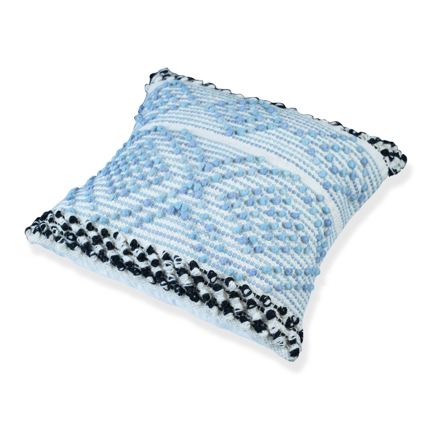 Angled view of a textured blue and white cushion cover featuring tufted diamond patterns and bold black-and-white braided edging on a clean white background.







