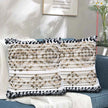 Boho throw pillow set on sofa with beige textured design and fringe