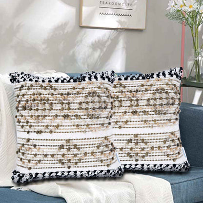 Boho throw pillow set on sofa with beige textured design and fringe