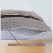 Side view of a grey tufted cushion showcasing a concealed zipper opening with an arrow label pointing to "Hidden Zipper" and revealing a neatly stitched interior lining.







