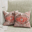Vintage red medallion throw pillows on green sofa.
