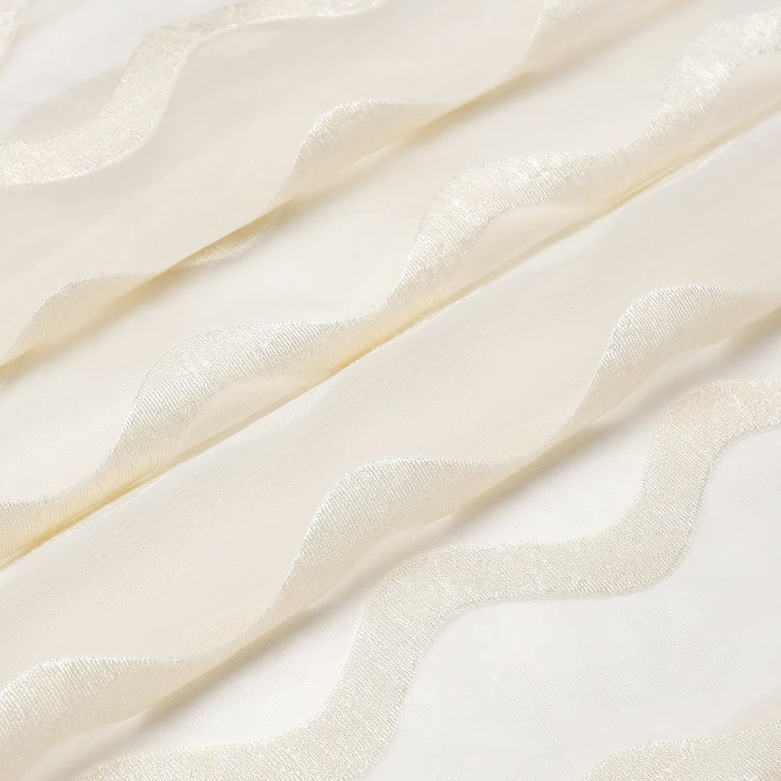 Close-up of sheer white fabric with a subtle pattern on a light background