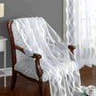 White quilted blanket draped over a wooden chair