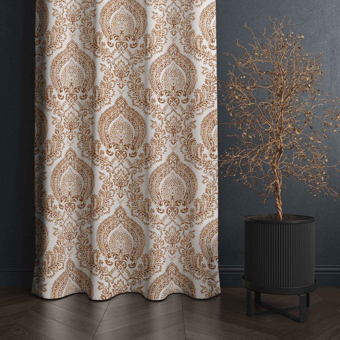 Brown damask curtain beside decorative potted tree.
