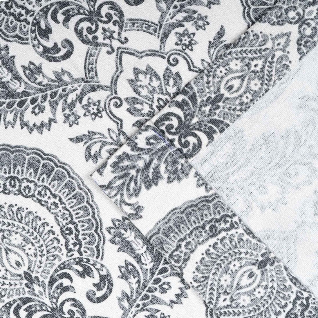 Close-up of gray damask print cotton curtain fabric .