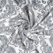 Twisted swirl of gray damask patterned cotton fabric 
