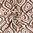 Brown and white geometric fabric with swirl fold.

