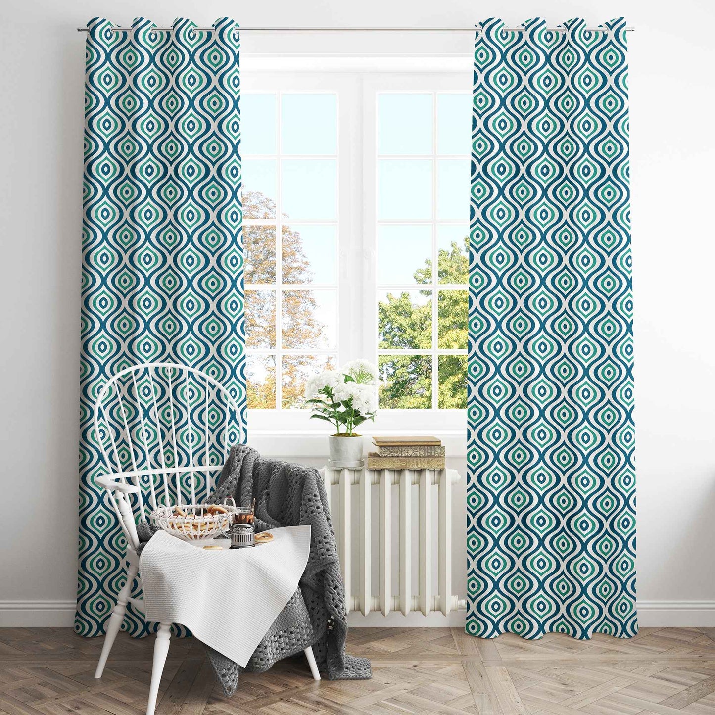 Bright dining nook with green and navy geometric patterned curtains, white spindle-back chair, and large window with natural light.