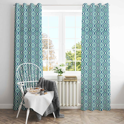 Bright dining nook with green and navy geometric patterned curtains, white spindle-back chair, and large window with natural light.