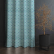 Blue diamond pattern curtain with modern potted plant
