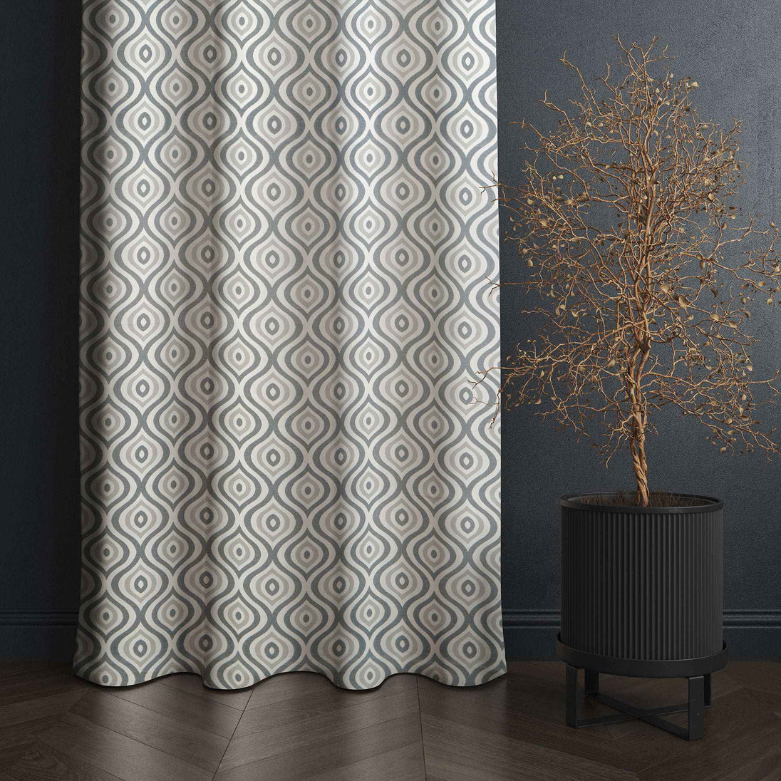 Gray geometric curtain next to modern potted plant.
