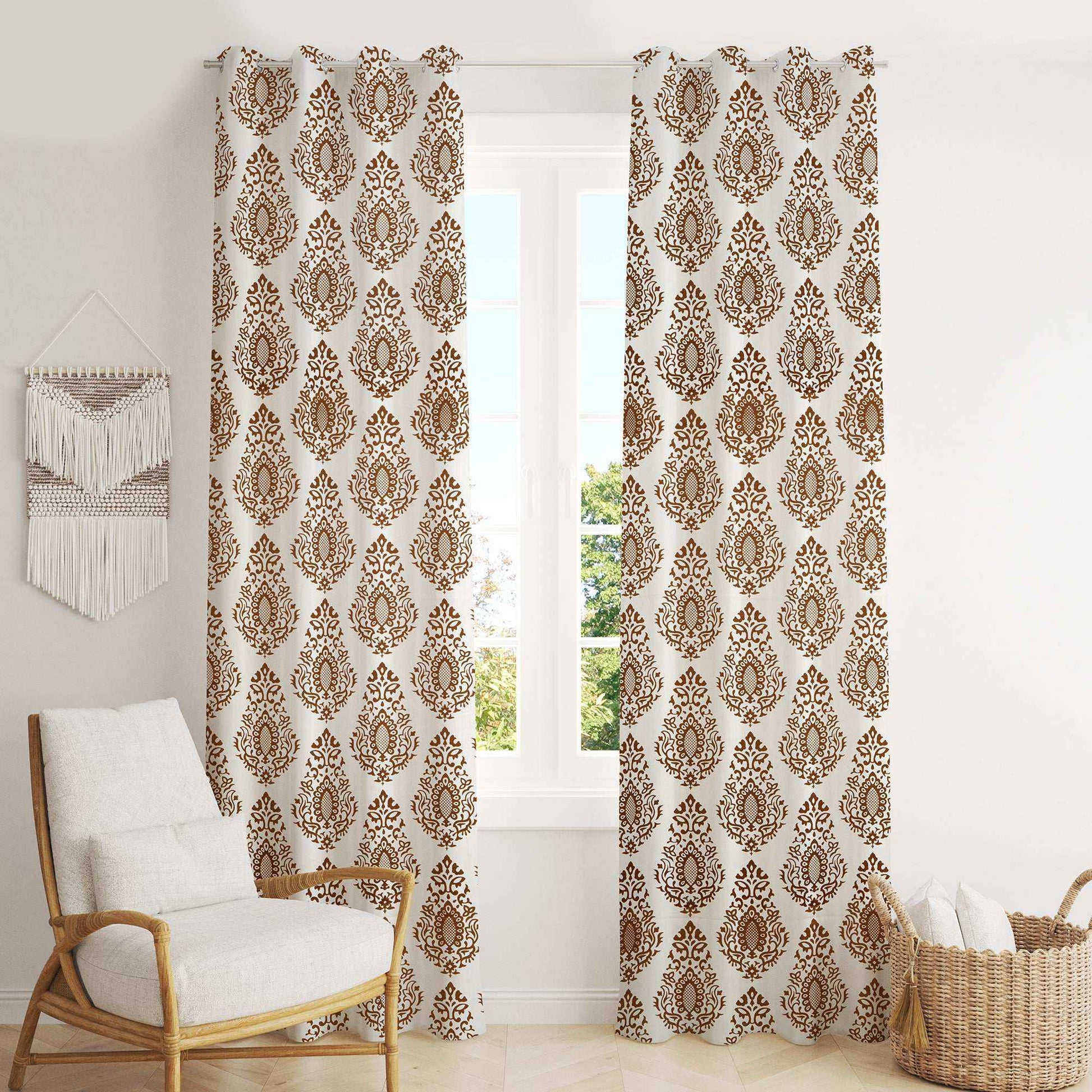 Elegant brown damask print curtains in a bright living room with white walls, cozy armchair, and wicker basket – perfect for classic and boho home décor styles.
