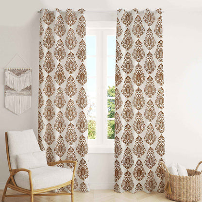 Elegant brown damask print curtains in a bright living room with white walls, cozy armchair, and wicker basket – perfect for classic and boho home décor styles.