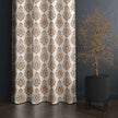 Brown damask curtain beside modern black planter







