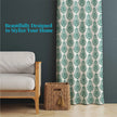 Green damask curtain styled with rattan and dark wall backdrop
