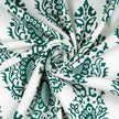 Green floral pattern on twisted white fabric.
