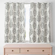 Short gray damask curtains above blush pink dresser

