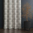 Gray damask curtain paired with black potted tree

