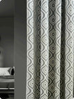 Modern bedroom curtains with bold geometric pattern.
