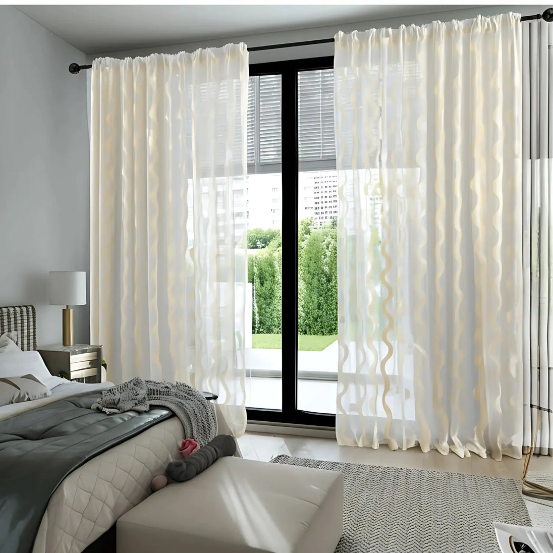 Modern bedroom with white curtains, bed, and lamp.