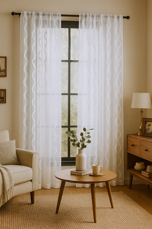 Full-length ocean sheer curtain panel on window









